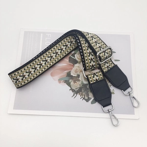 Close-up of ethnic woven nylon strap with adjustable metal hook and leather ends
