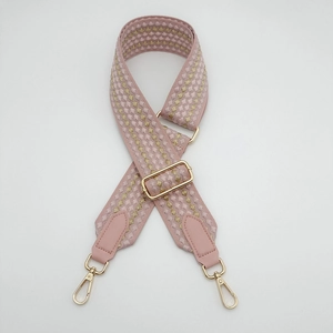 Close-up of pink wave jacquard 5cm wide bag strap with golden metal swivel hooks