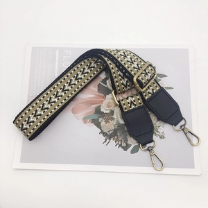 Detail of adjustable bohemian strap with khaki V-pattern weave and bronze metal hooks