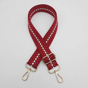 Close-up of adjustable red and white geometric woven strap with gold metal lobster clasps