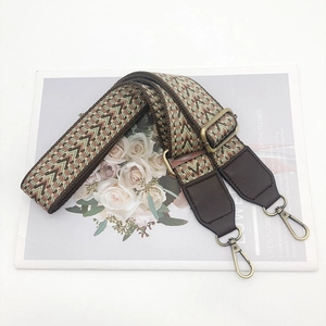 Close-up of bohemian woven strap with retro wave pattern and bronze metal lobster clasp