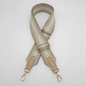 Detail of adjustable 5cm thick jacquard bag strap with gold metal hooks and PU leather ends