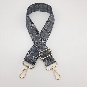 Adjustable wide nylon shoulder strap with black and white geometric pattern and gold hooks