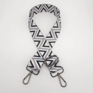 Close-up of adjustable geometric wave patterned wide nylon shoulder strap with metal hooks