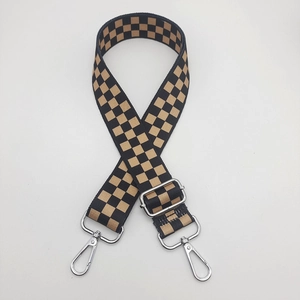 Close-up of black and yellow checkerboard nylon strap with silver metal lobster clasps