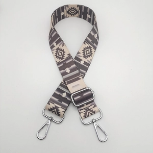 Close-up of ethnic geometric pattern nylon strap with silver metal swivel hooks