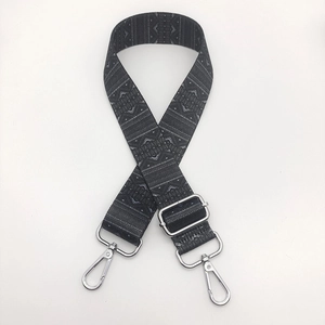 Detail of ethnic geometric patterned wide nylon bag strap with silver metal lobster clasps