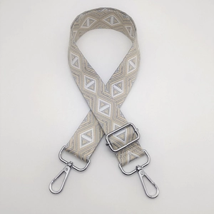 Detail of adjustable geometric weave strap with silver metal swivel hooks for handbags