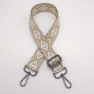 Detail of geometric diamond weave bag strap with adjustable gunmetal swivel hooks