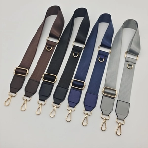 Detail showing four colors of adjustable nylon bag straps with golden D-ring buckles