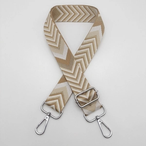 Close-up of adjustable woven shoulder strap with brown chevron patterns and silver hooks