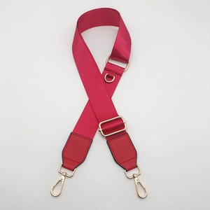 Adjustable red nylon shoulder strap with gold metal D-ring and swivel hooks