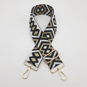 Close-up of ethnic geometric jacquard nylon strap with golden metal swivel hooks