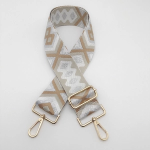 Close-up of ethnic jacquard pattern strap with golden metal buckle and lobster clasp