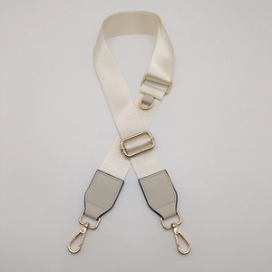 Adjustable wide cream nylon bag strap with gold lobster clasps and D-ring hardware