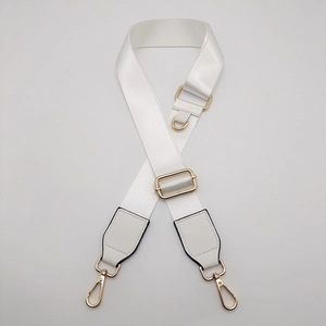 Close-up of adjustable white nylon strap with gold metal swivel clasps and hardware
