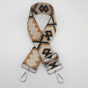Close-up of ethnic geometric pattern nylon strap with adjustable silver metal hooks