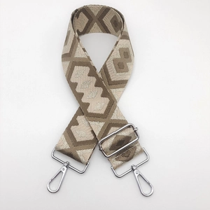 Close-up of ethnic geometric pattern nylon strap with silver metal swivel hooks and buckles