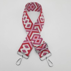 Detail of adjustable geometric canvas shoulder strap with metal hooks and hardware