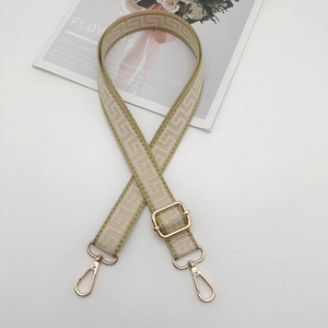 Close-up of vintage geometric pattern woven strap with gold adjustable metal hooks