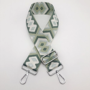 Close-up of geometric ethnic pattern on adjustable nylon shoulder strap with silver hooks