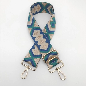 Detailed view of ethnic jacquard weave bag strap with golden zinc alloy metal hooks