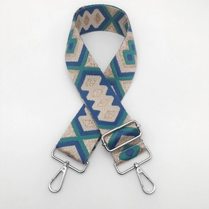 Close-up of ethnic geometric jacquard bag strap with silver metal swivel hooks