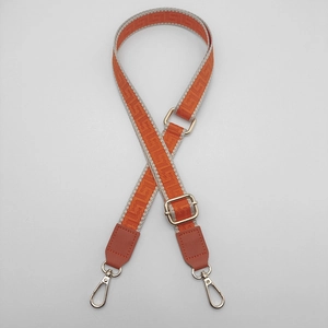 Adjustable orange geometric weave bag strap with silver metal hooks and leather trim