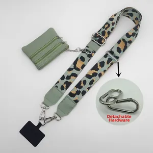 Detail view of sage green leopard print phone strap with detachable silver hardware