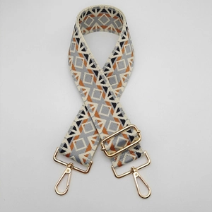 Detail of 5cm ethnic style wide woven jacquard shoulder strap with golden metal lobster clasps