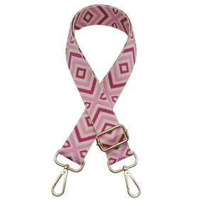 Detail of geometric woven bag strap with pink diamond patterns and gold metal lobster clasps