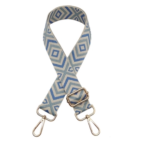Macro detail of geometric diamond pattern shoulder strap with gold metal lobster clasps