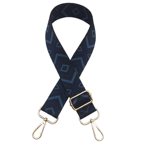 Detail of adjustable geometric diamond pattern bag strap with gold lobster clasps