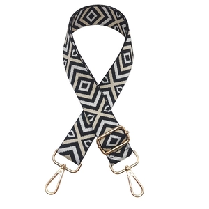 Close-up of geometric patterned woven replacement shoulder strap with gold metal hardware