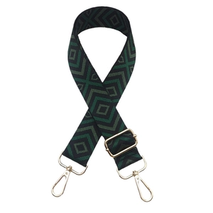 Macro view of adjustable dark green diamond pattern woven strap with gold metal hooks