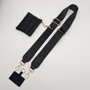 Detailed view of black nylon wide strap with a golden hook and a small leather coin purse