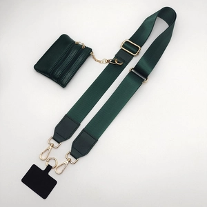 Detail of dark green wide nylon shoulder strap with leather coin purse and gold hardware