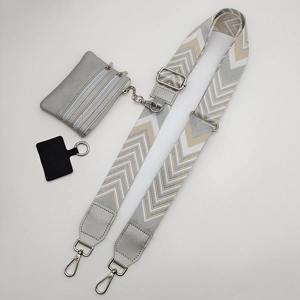 Detail view of woven V-pattern shoulder strap with small coin pouch and silver buckles