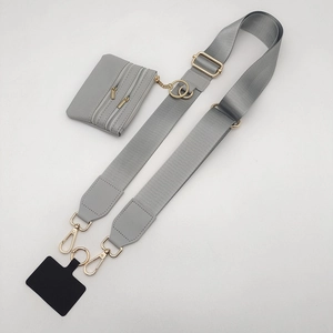 Detail of adjustable gray nylon strap with gold metal hooks and detachable coin purse