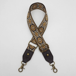 Detail of bohemian jacquard bag strap with vintage floral pattern and bronze metal hooks