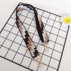 Adjustable wide canvas shoulder strap with geometric pattern and gold swivel hooks