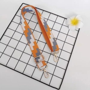 Adjustable wide canvas bag strap with orange geometric jacquard and gold metal hooks