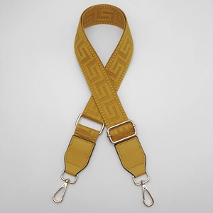 Adjustable mustard yellow woven shoulder strap with gold metal buckles and greek pattern