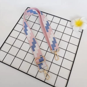 Detail of adjustable canvas wide shoulder strap with pink and blue geometric pattern