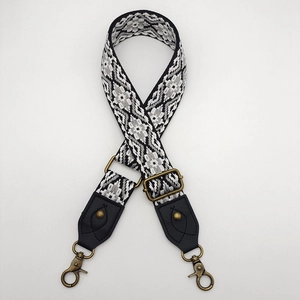 Detail of adjustable ethnic style woven bag strap with bronze metal lobster clasps