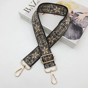 Close-up of ethnic floral jacquard bag strap with high-quality gold metal hooks