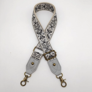 Detail of vintage damask pattern shoulder strap with bronze metal lobster clasps