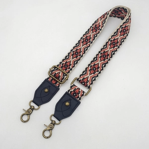 Close-up of bohemian geometric ethnic woven bag strap with vintage bronze metal hooks