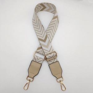 Detail of adjustable woven canvas strap with wave pattern and gold metal buckles