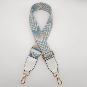 Adjustable geometric blue and beige canvas shoulder strap with gold metal buckles